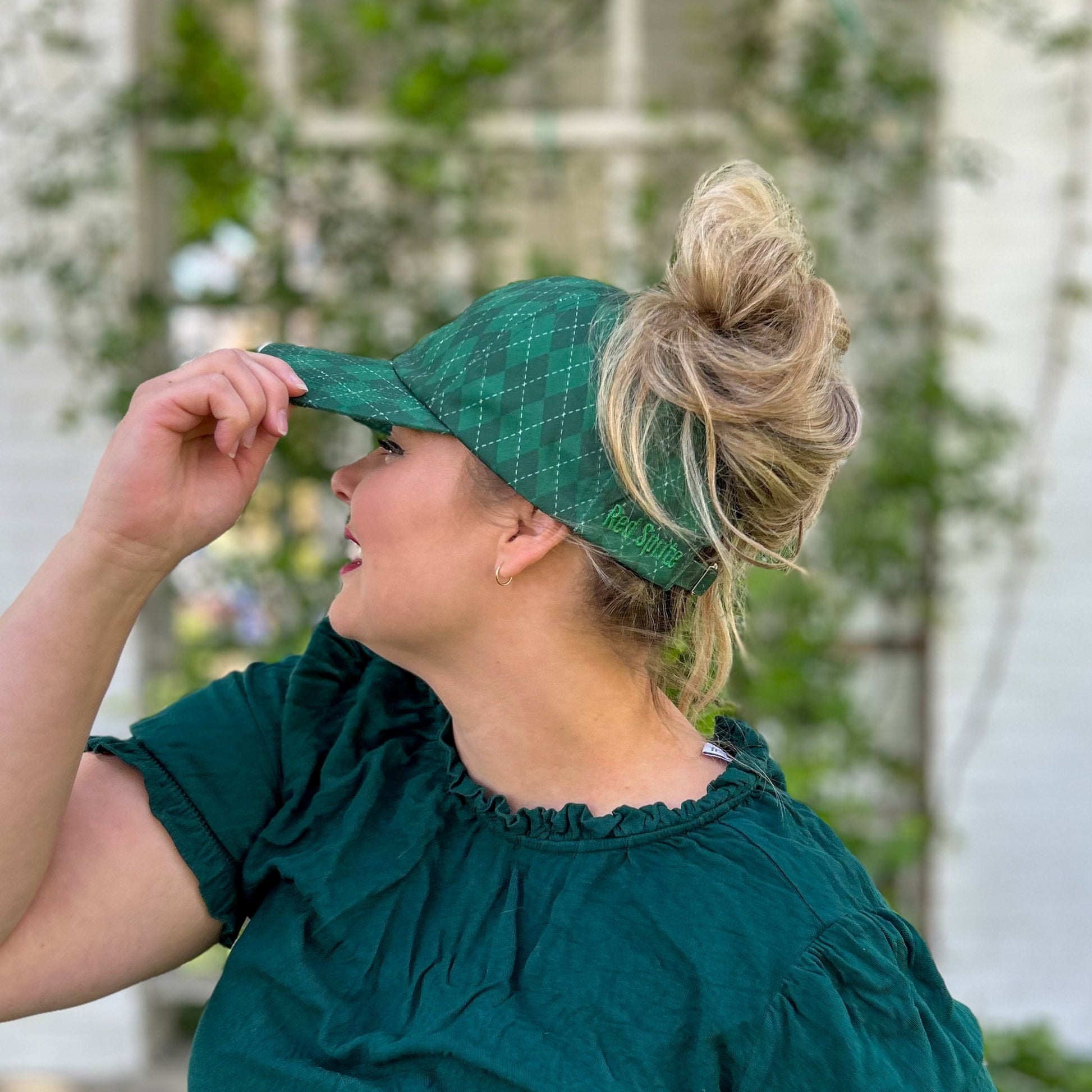 side view of messy bun baseball cap, red sprite hats, green argyle hat, slytherin baseball cap, harry potter house hat, hogwarts hat, green argyle golf hat