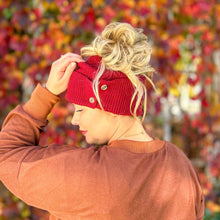 Load image into Gallery viewer, messy bun beanie knitted winter hat. side view of maroon button beanie. cc ponytail beanie
