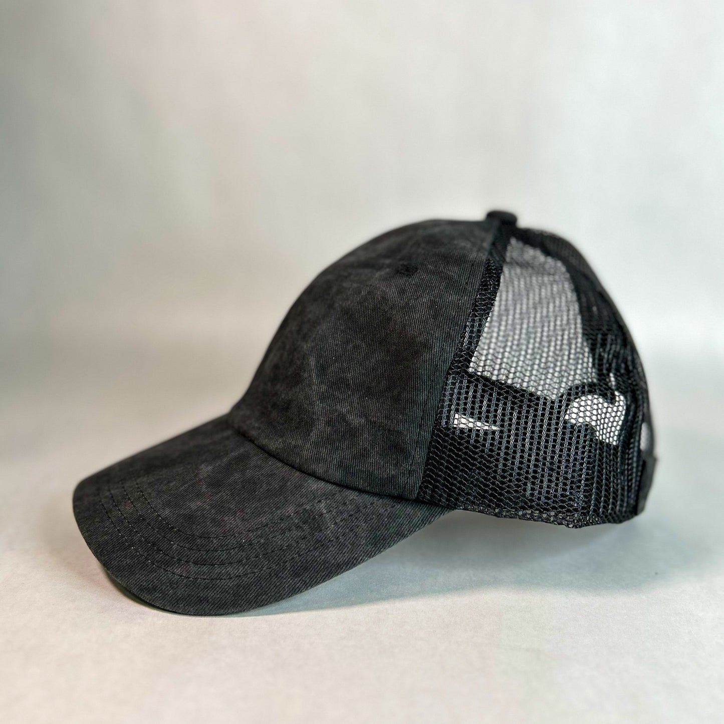 side view of red sprite hats ponytail cap washed black mesh back women's hat