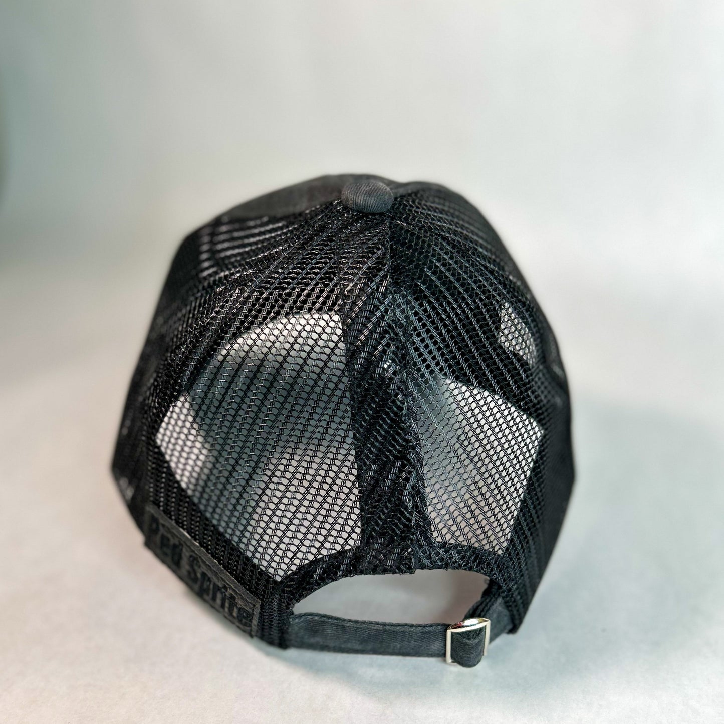 back view of hidden messy bun baseball cap, black mesh back women's hat