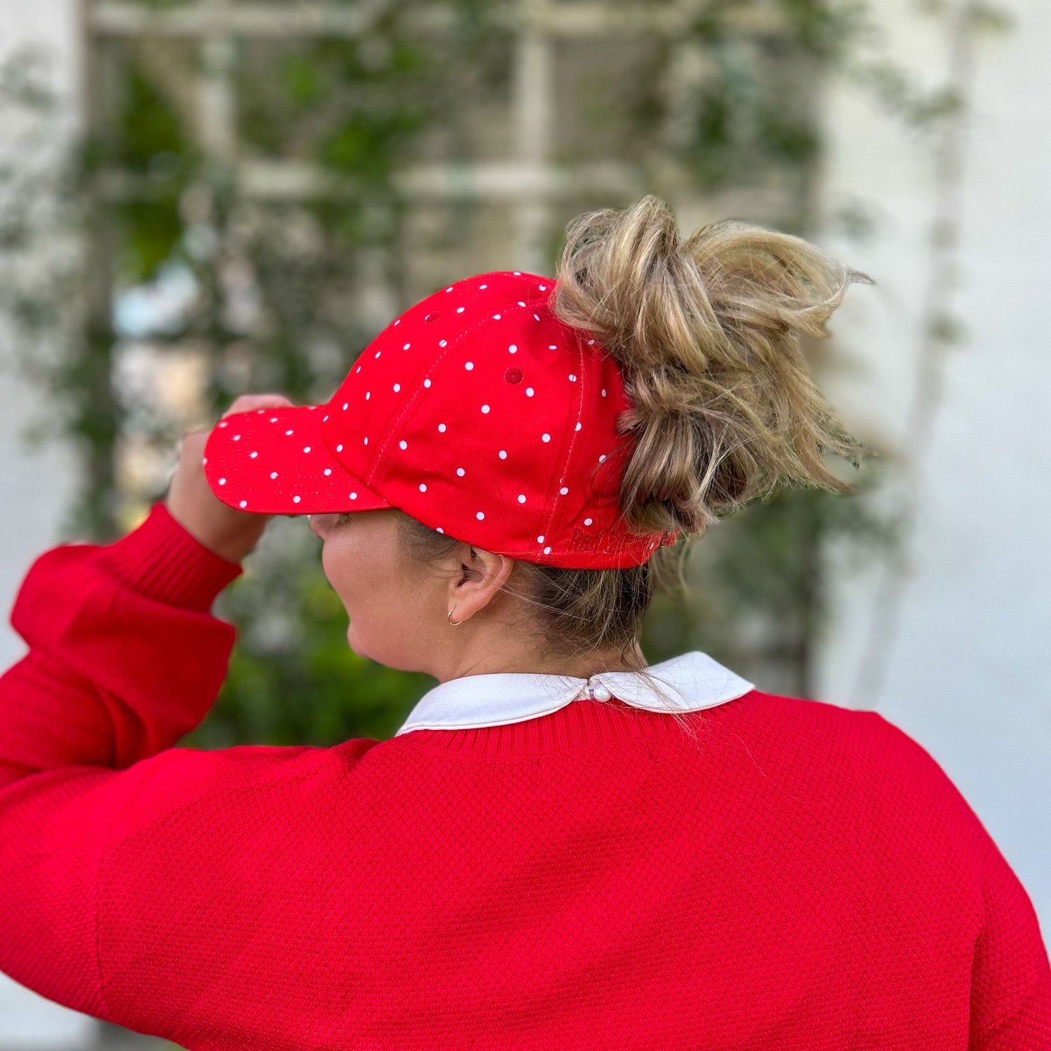 side view of red polka dot baseball cap, minnie mouse hat, disneyland cap, red sprite hats disney hat, red polka messy bun baseball cap, minnie and mickey ponytail cap