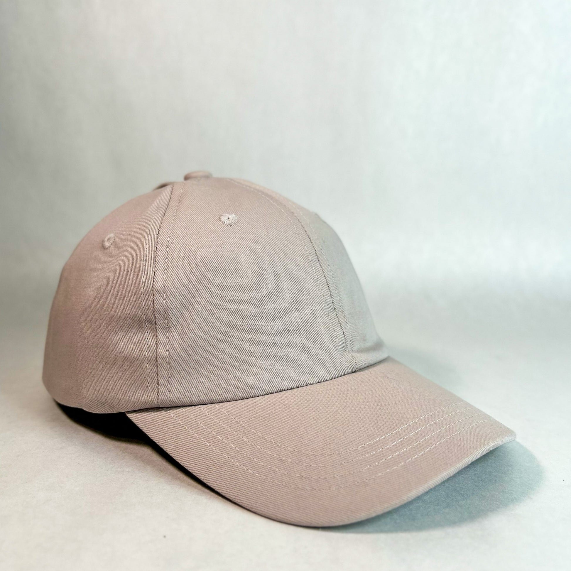 front side view of red sprite hats tan ponytail hat, women's hidden messy bun hat