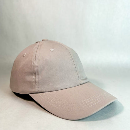 front side view of red sprite hats tan ponytail hat, women's hidden messy bun hat