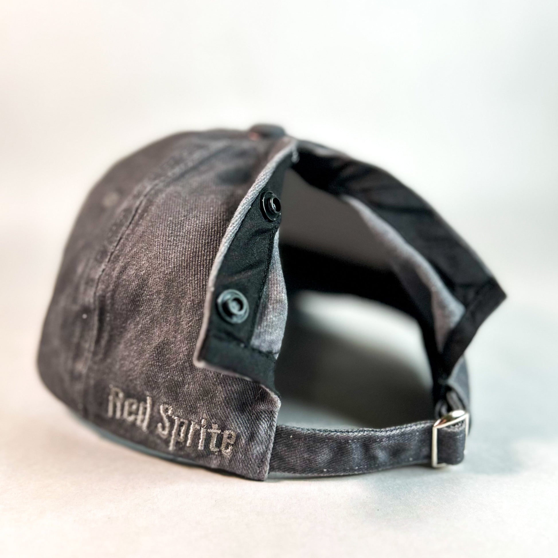 back view of hidden messy bun opening of dark grey women's baseball cap