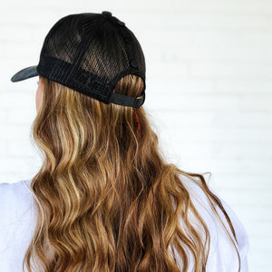 back view of black mesh back messy bun baseball cap with black snap-up snaps red sprite hats easy down hairstyle