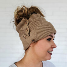 Load image into Gallery viewer, side view of red sprite hats light mocha button up beanie with high messy bun
