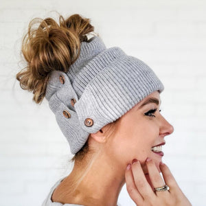 side view of red sprite hats heather gray button-up beanie with high messy bun