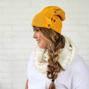 side view of mustard button up beanie with messy side braid red sprite hats mabel mora beanie dupe