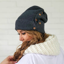 Load image into Gallery viewer, side view of female wearing dark grey red sprite hats button up beanie with long messy side braid
