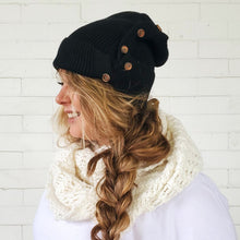 Load image into Gallery viewer, side view of red sprite hats black button up messy bun beanie with long messy side braid 
