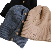 Load image into Gallery viewer, 3 button-up beanies laid down with buttons facing up: light mocha brown beanie, dark grey, and black beanies
