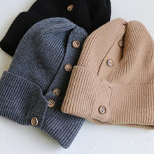 Load image into Gallery viewer, brown, dark grey, and black button up beanies laid out
